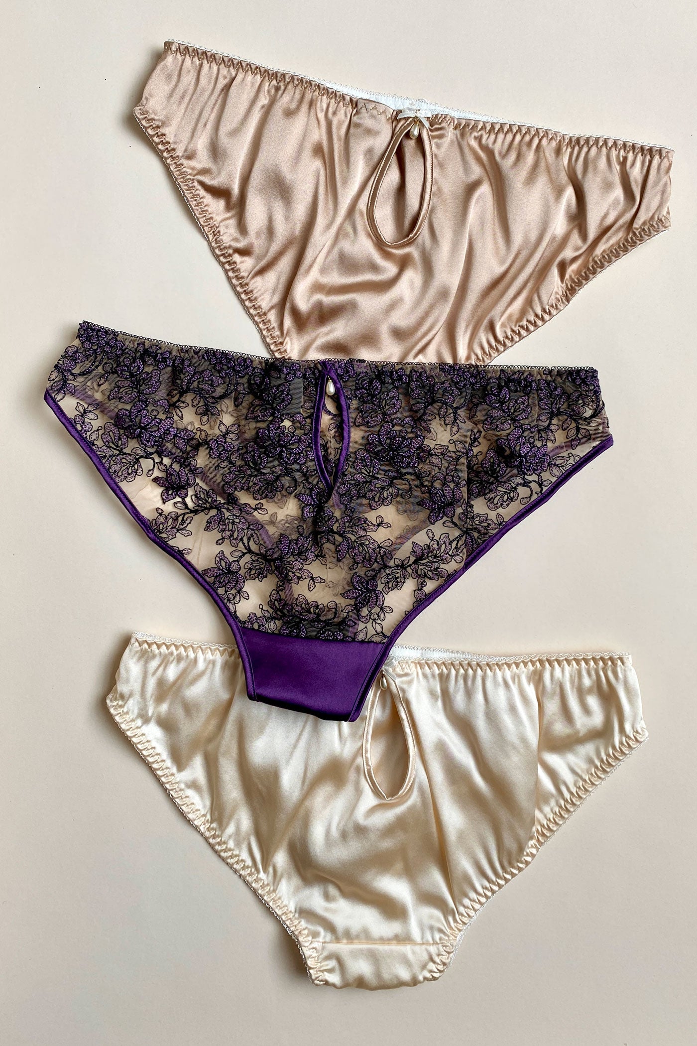 Back view of set of 3 luxury panties with keyhole pearl details