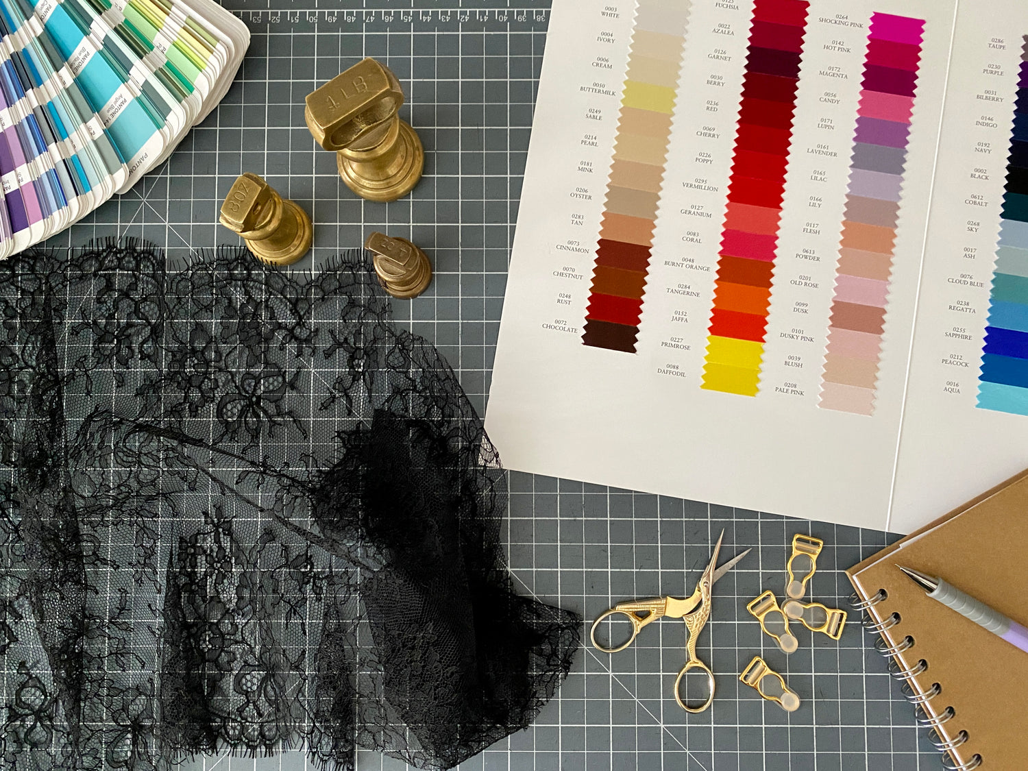 Fabric swatch card, lace, scissors and pattern weights