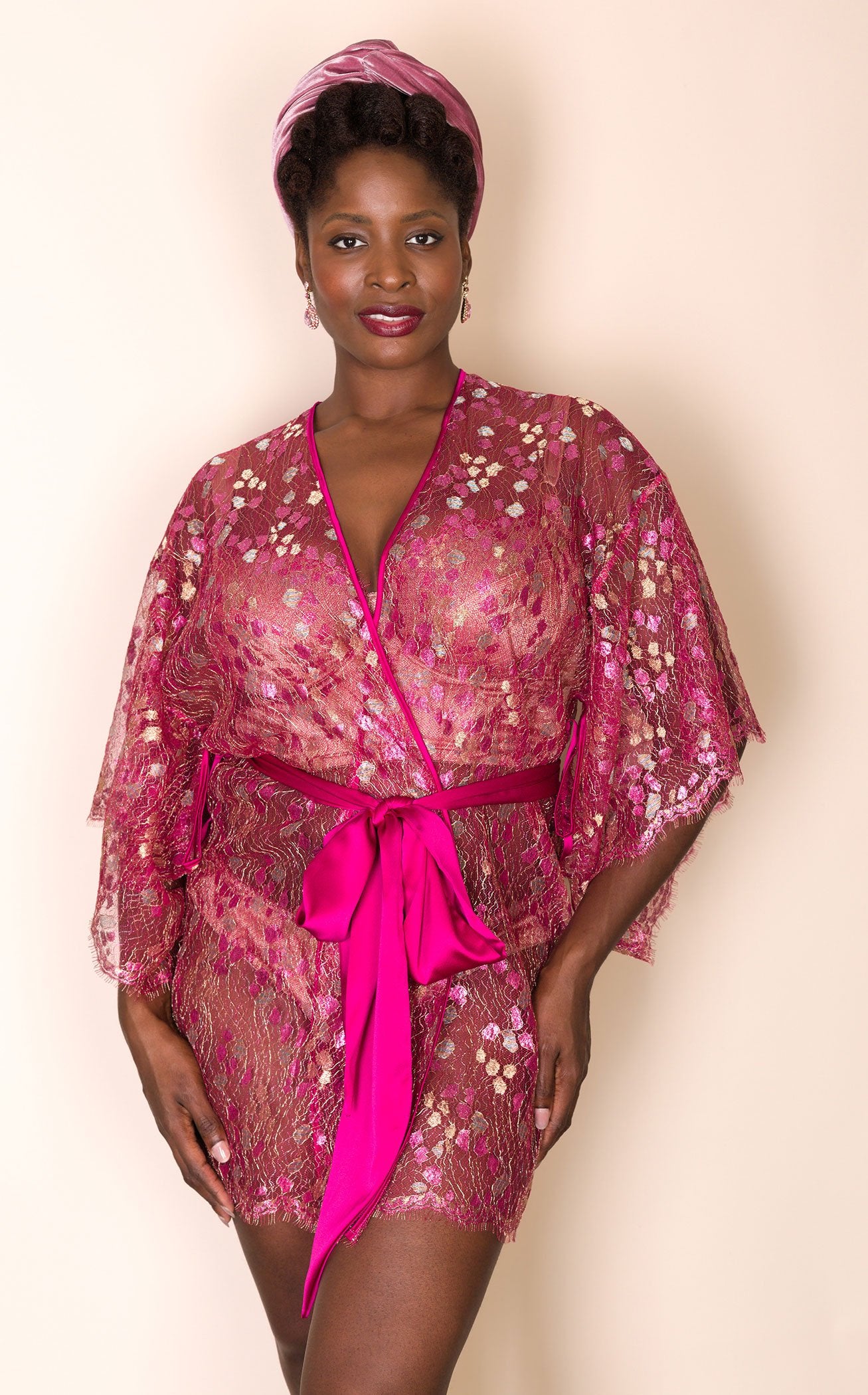 Luxury lace robe in metallic bright pink worn closed over silk lingerie