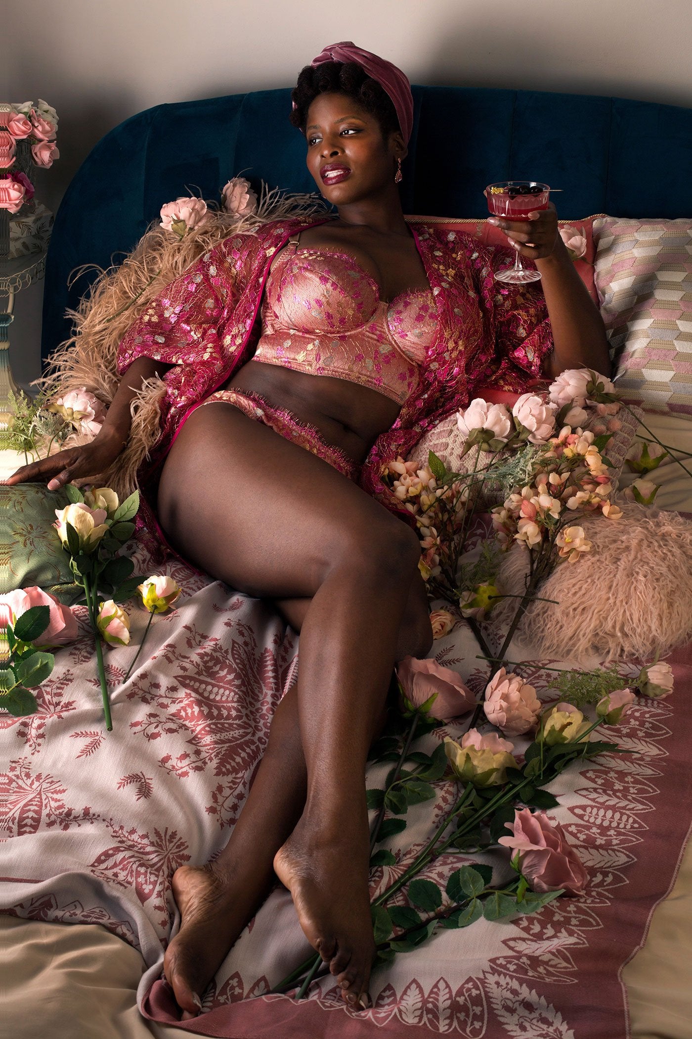 Pink metallic lace robe worn over matching longline bra lingerie set with pink cocktail and flowers