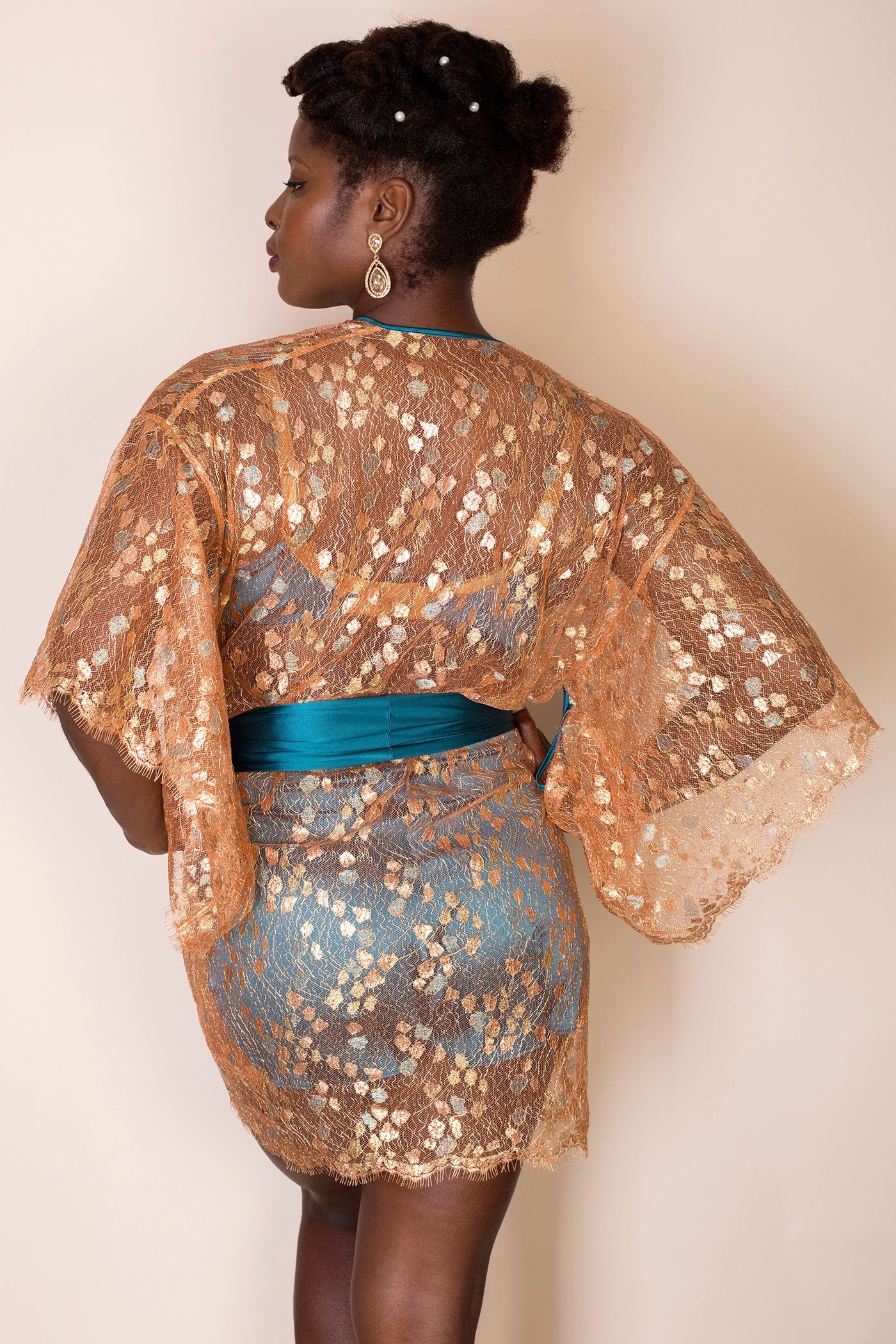 Sheer gold lace robe back view with all over lace sleeves and bright blue silk belt