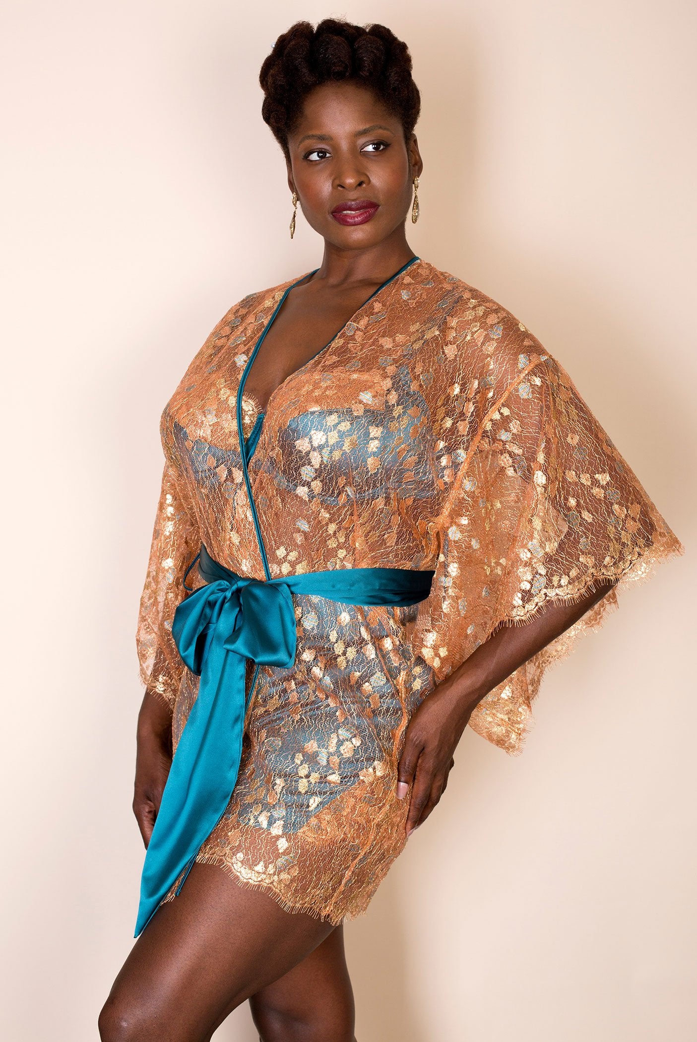 Sleeve detail on metallic gold lace dressing gown, with blue silk belt 