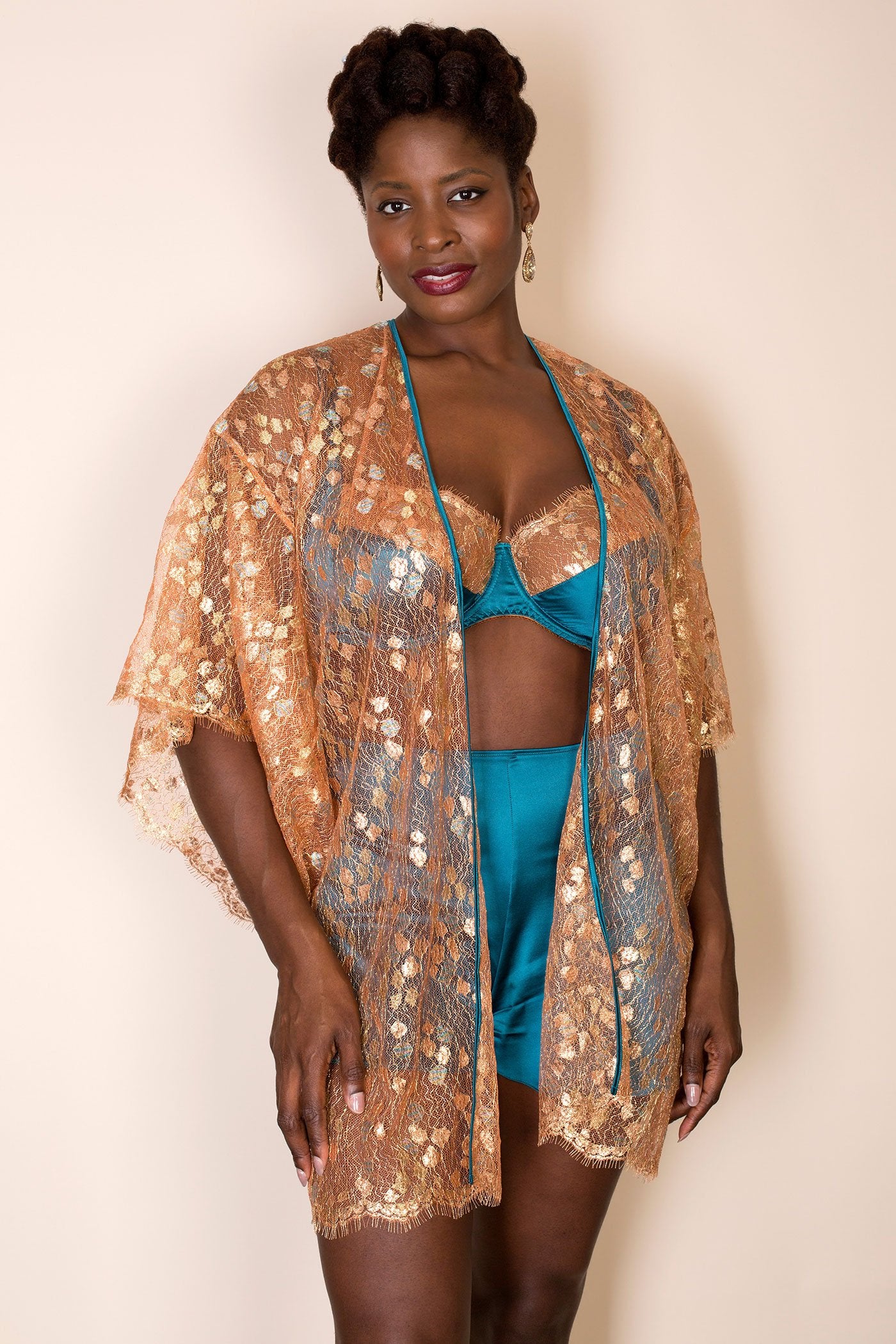 Gold lace robe worn open with coordinating turquoise silk bra and tap pants