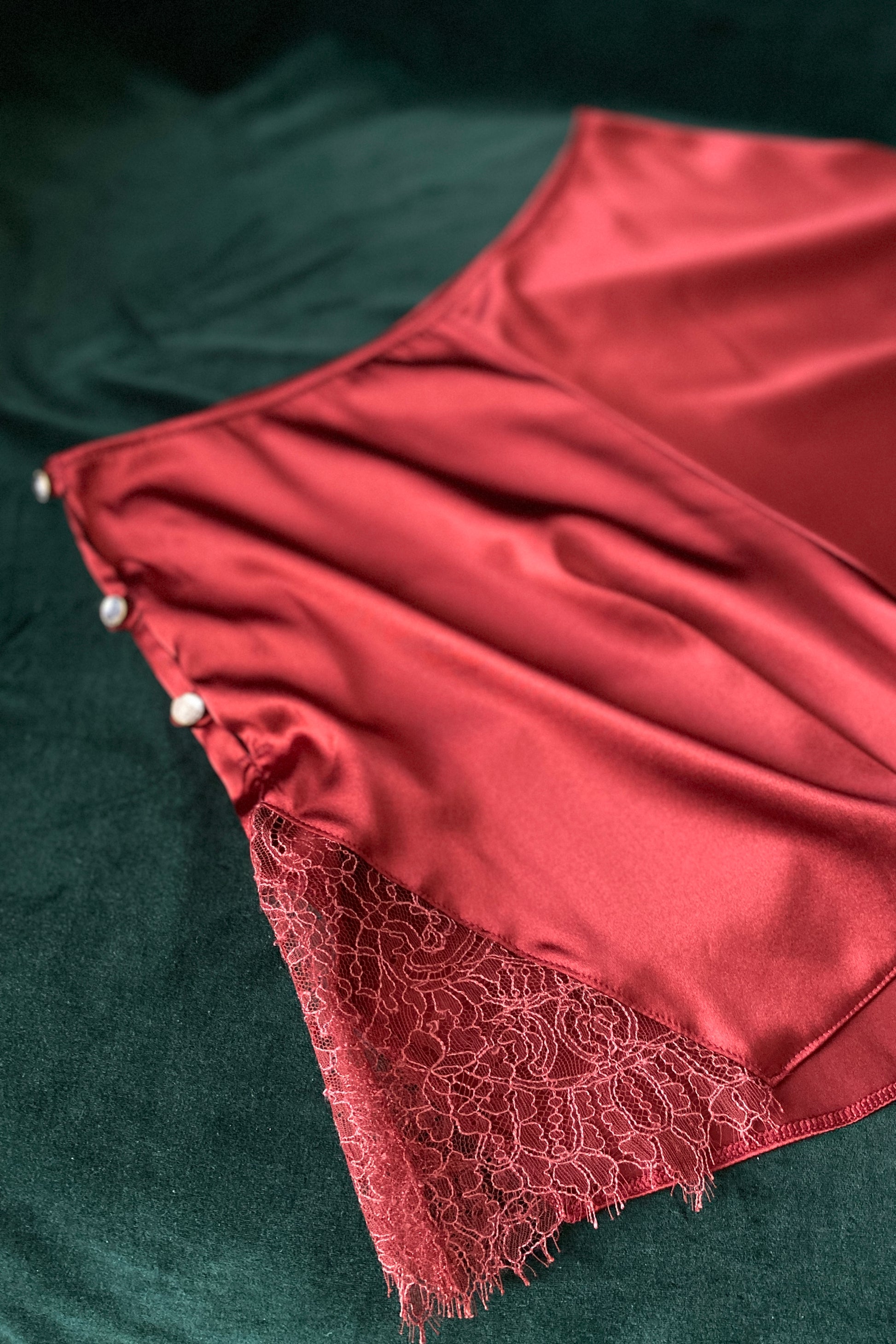 Lace detail of dark red silk vintage style tap pants and crystal button fastening