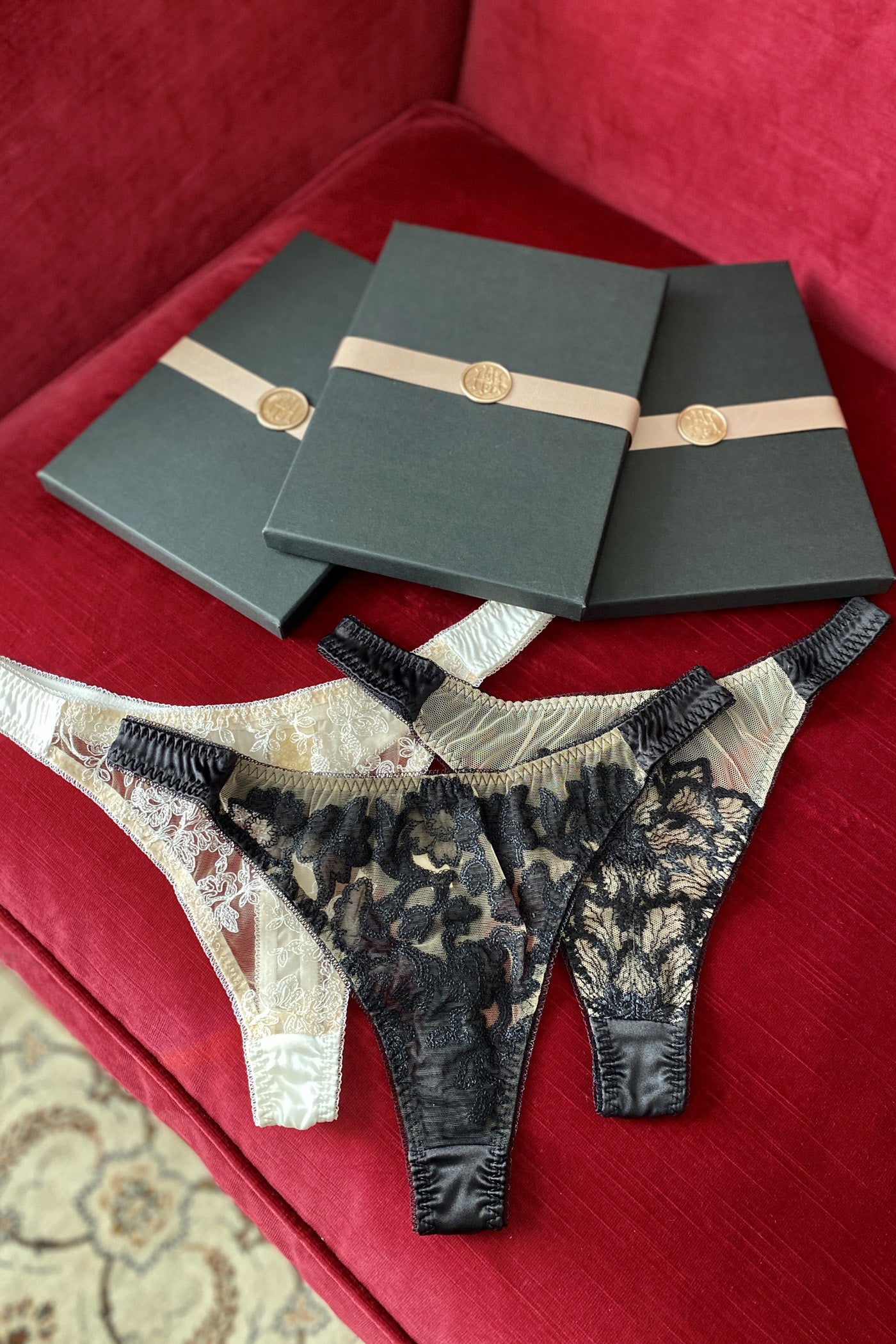 Gift set of luxury silk and sheer embroidery thongs in black, ivory and gold with black and gold gift boxes